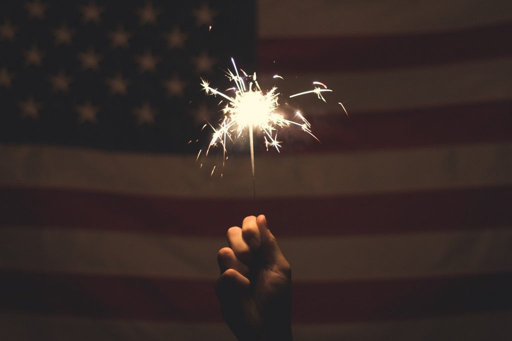 flag with a sparkler in the foreground